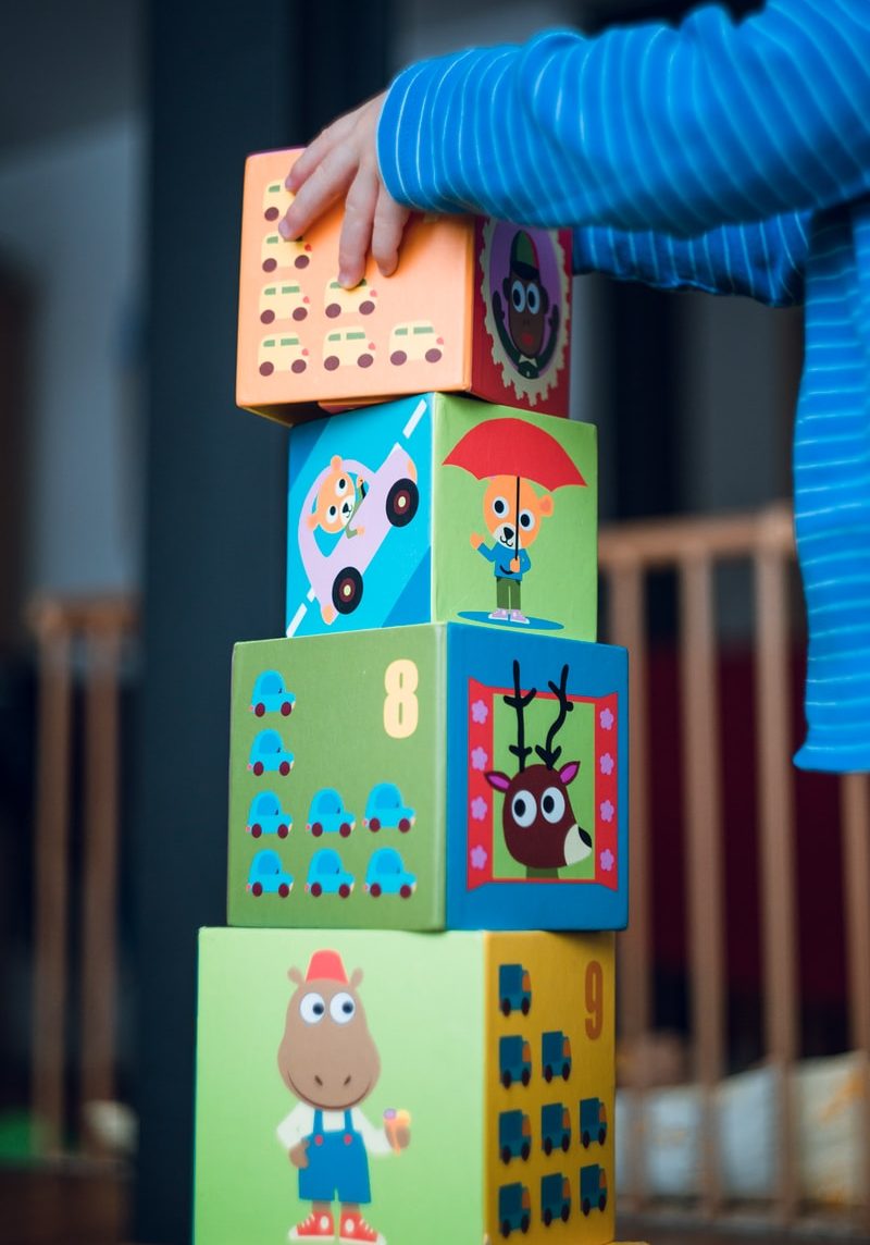 child building an four boxes